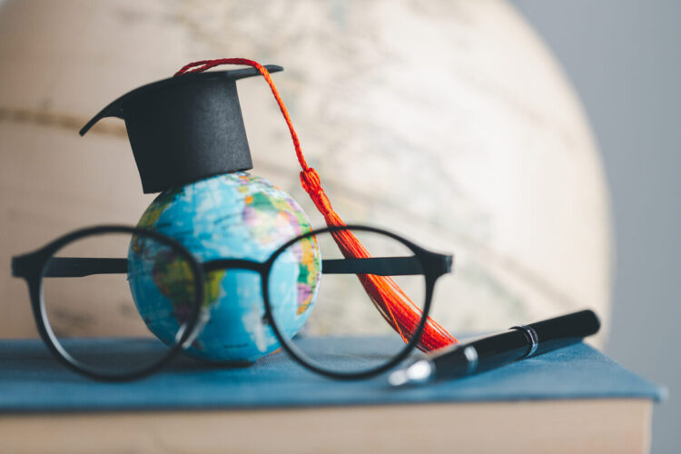 Graduation cap with Earth globe. Concept of global business study, abroad educational, Back to School. Education in Global world, Study abroad business in universities in worldwide. language study
